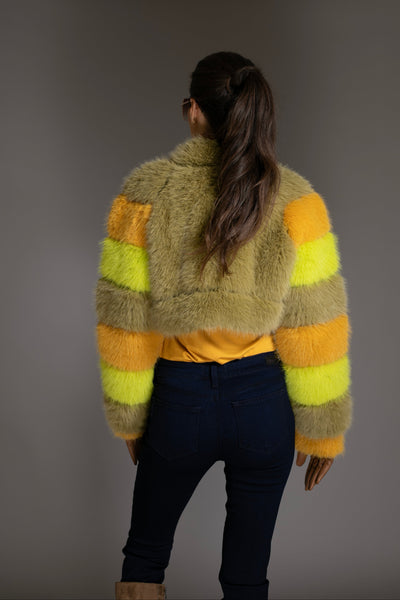 Person wearing a colorful sweater with a neutral background